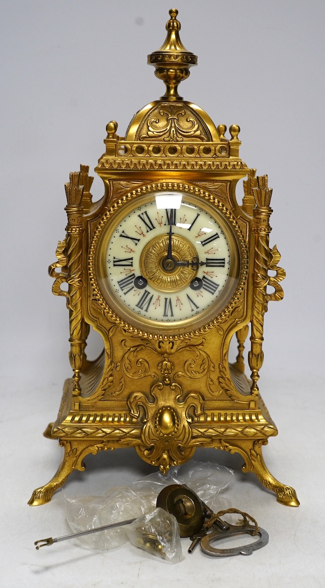 An early 20th century French ormolu mantel clock with key and pendulum, 33cm. Condition - good, not tested as working